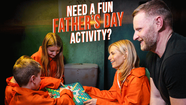 family playing in an escape room wearing orange prison jumpsuits as one of the activities for Top Fathers Day Activities